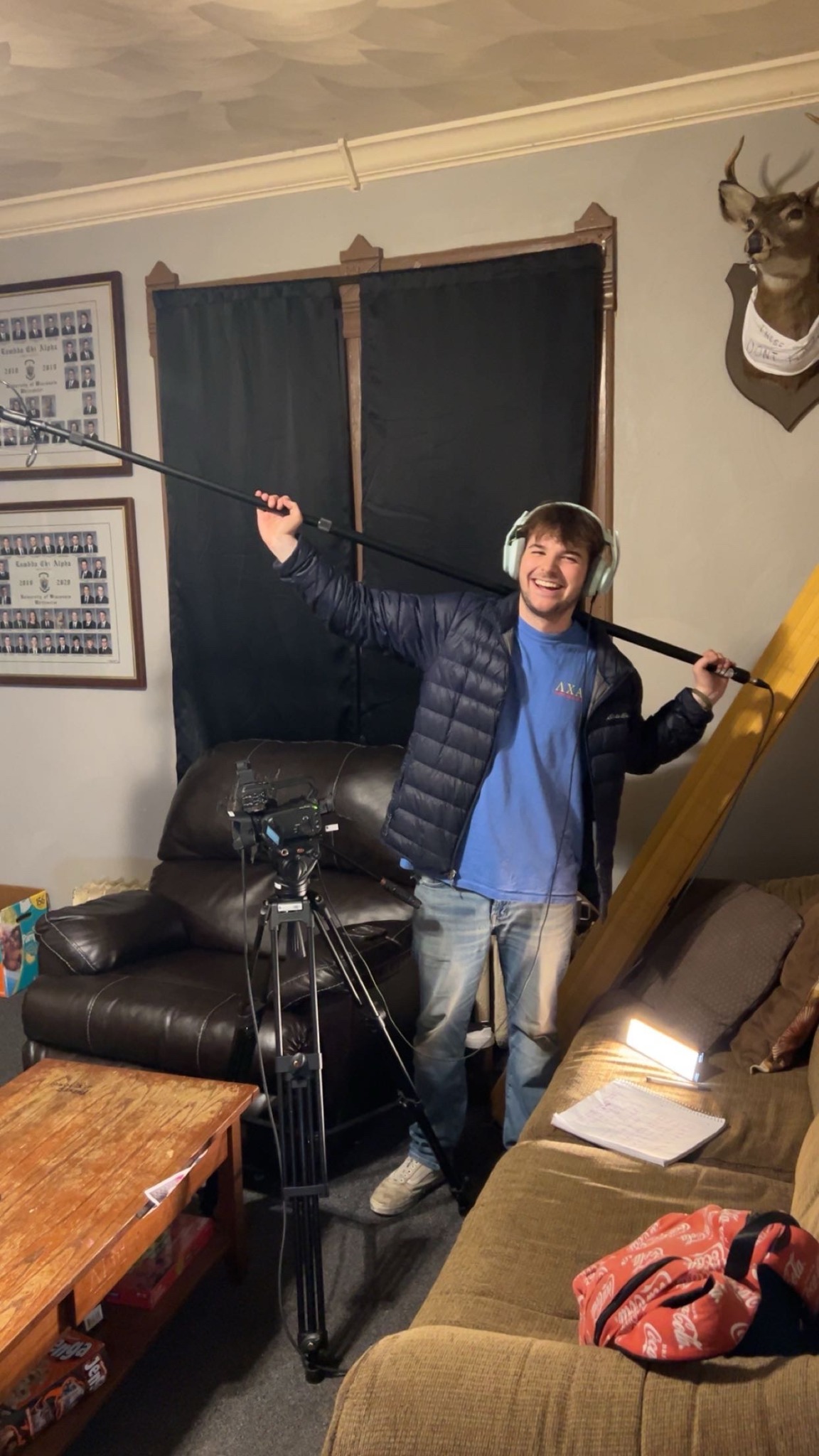 Ryan Hoke operating a boom microphone on a television production
